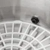 A close-up view of the interior of a stainless steel pot, showing a white plastic grid insert and a black threaded fitting on the side. Náhľad obrázku produktu