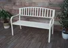 A white metal garden bench is shown in a room with a wooden plank wall and a wooden floor. There are two potted plants on either side of the bench. Produktbild-Vorschau
