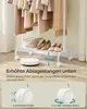 A white garment rack with clothes hanging on it, shoes on the lower shelf, and a robot vacuum cleaner below. The image highlights the space under the rack for the robot vacuum. Produktbild-Vorschau