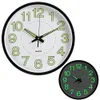 Two glowing wall clocks are shown against a white background. One clock is larger and in the foreground, while a smaller one is in the background. Voir les images du produit