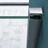 A close-up view of a shower enclosure's corner fitting, showing the glass and metal components against a blue wall and a textured background. Produktbild-Vorschau