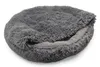 A round, fluffy gray pet bed is shown from a slightly elevated side angle. Produktbild-Vorschau