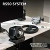 A gaming setup on a desk, featuring a monitor, steering wheel, pedals, and a direct drive wheel base. Produktbild-Vorschau