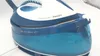 Close-up of a blue and white Philips PerfectCare Compact steam generator iron, showing the water tank and top casing. Anteprima dell’immagine prodotto