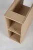 A close-up, high-angle shot of a light oak bathroom cabinet with two shelves. Podgląd zdjęcia produktu