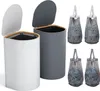 Two laundry baskets with lids, one white and one gray, and four laundry bags filled with clothes. Podgląd zdjęcia produktu