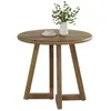 A round wooden table with a vase of greenery and a teacup on it. Anteprima dell’immagine prodotto