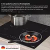 A close-up shot of a black induction cooktop with a pot and a frying pan with shrimp on it. Text overlays describe the product's features. Produktbild-Vorschau