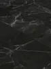 A close-up view of black marble-look vinyl flooring tiles. Produktbild-Vorschau