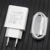 A white Huawei SuperCharge power adapter and a white USB-C cable are displayed on a black ribbed surface. Produktbild-Vorschau