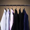 Several shirts hanging on a rack. Produktbild-Vorschau