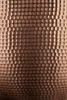 A close-up view of a hammered copper bowl's textured surface. Podgląd zdjęcia produktu