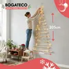 A woman is decorating a wall-mounted Christmas tree made of wooden sticks with fairy lights. Podgląd zdjęcia produktu