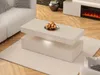 A modern living room with a white couch, a light-colored coffee table with decorative spheres, and a fireplace in the background. Náhled obrázku produktu