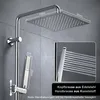 A close-up view of a modern chrome shower system mounted on a gray tiled wall, with dimensions indicated. Produktbild-Vorschau