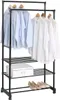 A black metal and plastic garment rack with three shelves, holding several light blue and white shirts, a white box, and a pair of beige shoes. Náhled obrázku produktu