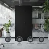 A black metal cabinet is shown in a modern office or industrial setting, with plants and office chairs visible in the background. Icons representing different use cases are displayed at the bottom. Voir les images du produit