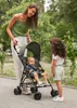 A mother and two children in a park with a stroller. Produktbild-Vorschau