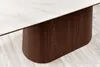 Close-up shot of a modern dining table with a white marbled top and a curved wooden base. Produktbild-Vorschau