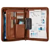 An open brown leather business portfolio with various compartments and items inside. Náhľad obrázku produktu