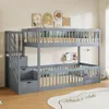 A gray wooden bunk bed with stairs and drawers, set up in a child's bedroom with wall art and decorations.