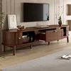 A modern wooden TV stand with a TV mounted on the wall above it, in a living room setting. Podgląd zdjęcia produktu