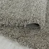 A close-up view of a shaggy rug, showing its texture and the underside where it is rolled. Náhľad obrázku produktu