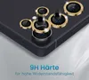 Close-up view of multiple camera lens protectors with gold, jeweled rims on a dark surface, with text overlay. Produktbild-Vorschau