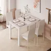 A dining table set with four chairs in a dining room. Produktbild-Vorschau