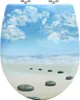 A toilet seat with a printed image of a beach scene. Produktbild-Vorschau