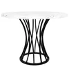 A round dining table with a white marble-look top and a black, sculptural base. Náhled obrázku produktu