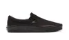 A black Vans slip-on shoe is shown from the side against a white background. Podgląd zdjęcia produktu