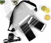 A transparent waterproof bag with two smartphones and an AirPod case inside, along with decorative lemon slices. Náhled obrázku produktu