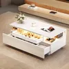 A modern white coffee table with drawers and integrated LED lighting, placed on a carpeted floor. Podgląd zdjęcia produktu