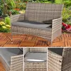A rattan garden bench with a gray cushion is shown in a garden setting, with close-up views of the cushion and bench construction. Voir les images du produit