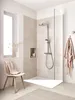 A modern bathroom with a walk-in shower, a chair, and a window. Produktbild-Vorschau