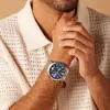 A man wearing a watch and a knitted sweater. Podgląd zdjęcia produktu