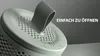 Close-up of a dehumidifier lid with a tab being lifted, against a grey background. Produktbild-Vorschau
