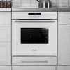 A white built-in oven with a digital display is shown in a modern kitchen setting. The oven is surrounded by light gray cabinets and a stainless steel countertop. Produktbild-Vorschau