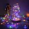 A glass dome filled with colorful LED string lights sits on a surface, with more lights scattered around it and a decorative cactus in the background. Produktbild-Vorschau