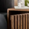A close-up shot of the slatted wooden front of a nightstand. Produktbild-Vorschau