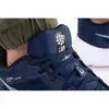 A close-up shot of a person wearing a blue Nike shoe. Anteprima dell’immagine prodotto