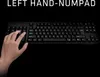 A hand is shown typing on a black keyboard against a black background. Podgląd zdjęcia produktu