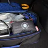 A desiccant bag with text on it is placed inside an open blue and black bag, which appears to be in the trunk of a car. Anteprima dell’immagine prodotto