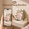 A vanity mirror with lights on a desk, with a phone in the foreground showing a reflection of the mirror. Náhľad obrázku produktu