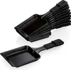 A stack of black raclette pans and one individual raclette pan. Produktbild-Vorschau