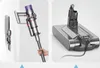 A split image showing a hand holding a vacuum cleaner and a charging dock for a vacuum cleaner. Anteprima dell’immagine prodotto