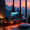 A computer setup with speakers and a monitor in front of a large window with a mountain view at sunset. Produktbild-Vorschau