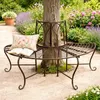 A curved metal bench surrounds a tree in a garden setting. Náhled obrázku produktu