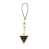 A Guess charm with a triangular metal logo and rhinestones, attached to a black string, isolated on a white background. Podgląd zdjęcia produktu